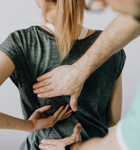 Person with pre-existing condition of back pain going to the doctor