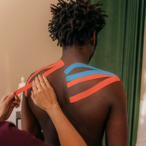 Man with pre-existing shoulder pain receiving althletic tape